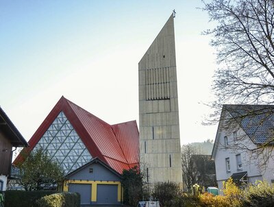 Der knapp 34 m hohe Glocken- und Aussichtsturm in Bleibach ergänzt als separater Bau die Kirche aus den 1970er- Jahren und nimmt die steilen Linien des Bestandsdachs auf.