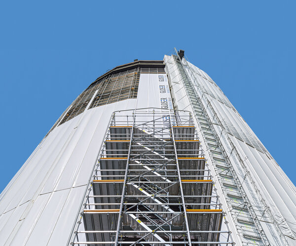 Turmaufnahme aus der Froschperspektive zeigt Einhausung im Gerüstbau